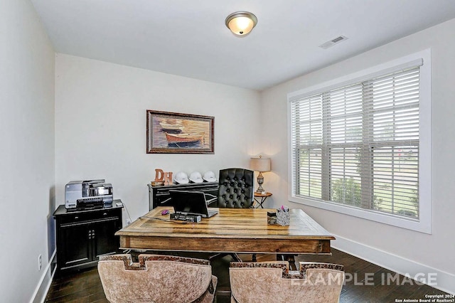 office area with dark wood finished floors, visible vents, and baseboards