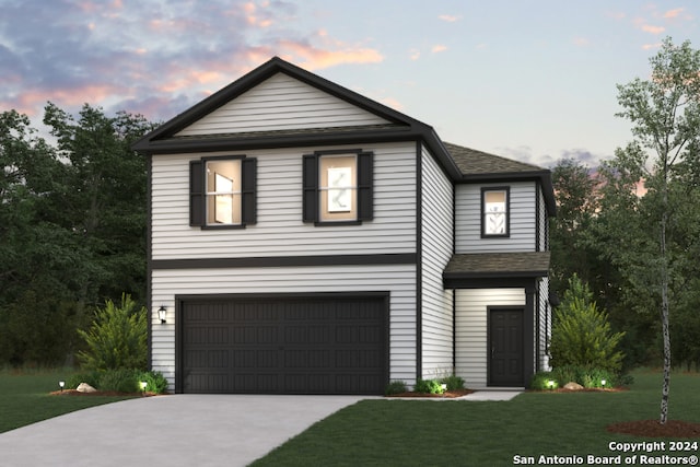 view of front facade featuring a garage and a yard