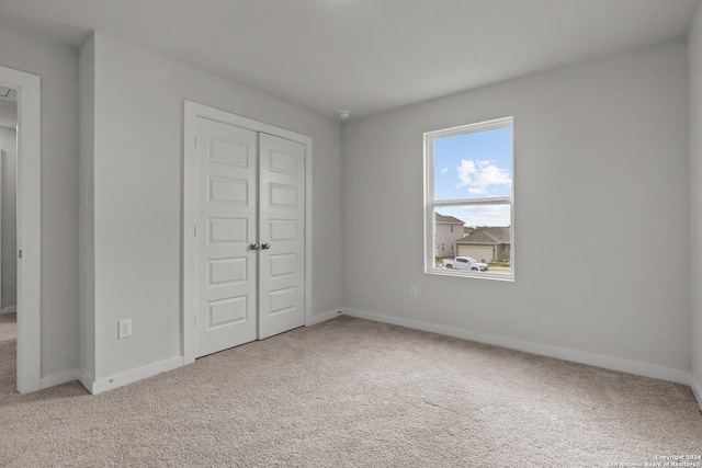 unfurnished bedroom with carpet and a closet