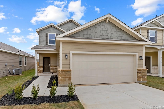 view of front of home featuring cooling unit, an attached garage, driveway, and stone siding