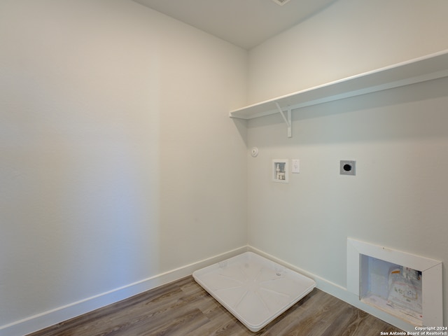 clothes washing area with washer hookup, gas dryer hookup, wood-type flooring, and hookup for an electric dryer