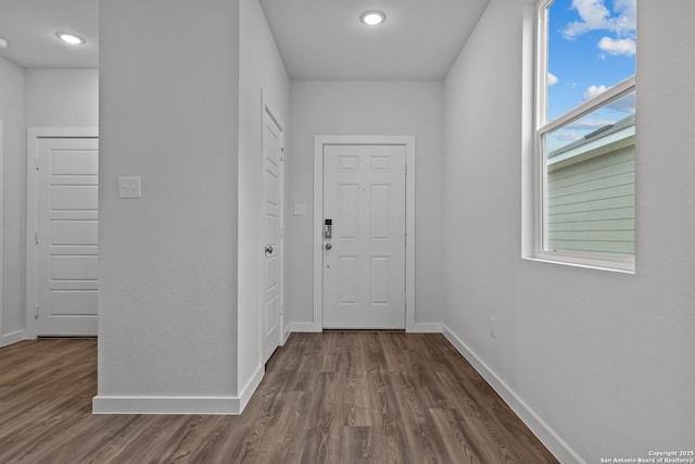 hall with recessed lighting, baseboards, and dark wood finished floors