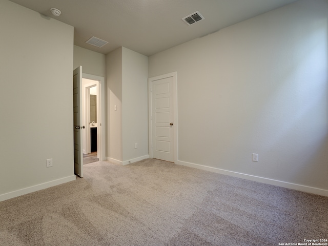 unfurnished room with light carpet