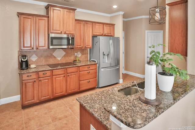 kitchen with tasteful backsplash, hanging light fixtures, dark stone countertops, crown molding, and stainless steel appliances