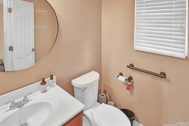 bathroom with toilet and vanity