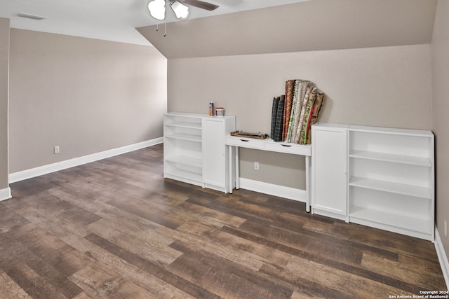 interior space featuring lofted ceiling, dark hardwood / wood-style floors, built in desk, and ceiling fan