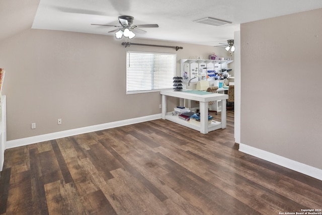 interior space featuring ceiling fan, lofted ceiling, and dark hardwood / wood-style floors