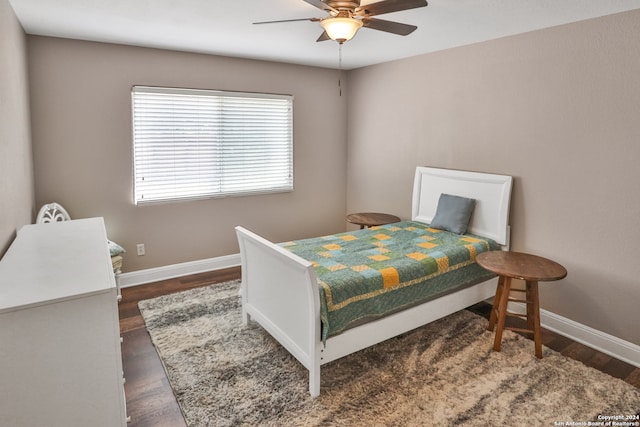 bedroom with dark wood-type flooring and ceiling fan