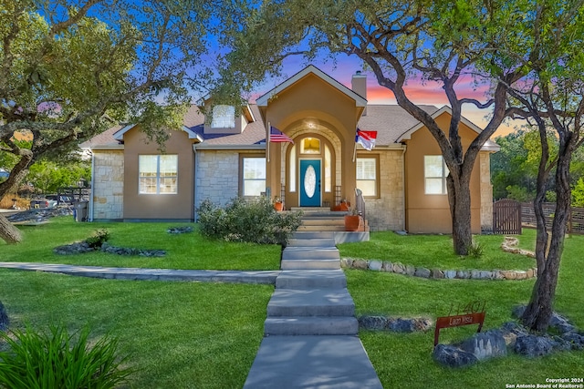 view of front of property with a yard