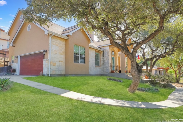 view of front of property with a front lawn and a garage