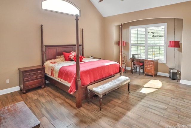 bedroom with ceiling fan, vaulted ceiling, and hardwood / wood-style floors