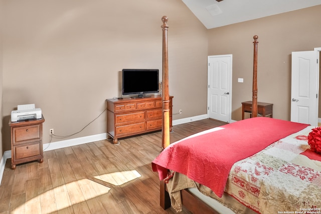 bedroom featuring lofted ceiling and light wood-type flooring