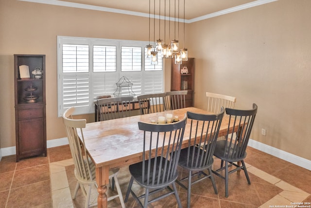 tiled dining area with crown molding and a notable chandelier