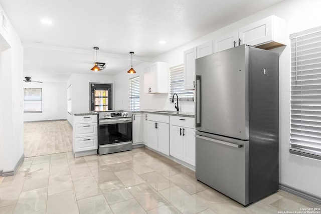 214 Oriole, San Antonio, TX 78228 - kitchen with ceiling fan, appliances with stainless steel finishes, a sink, a peninsula, and white cabinetry