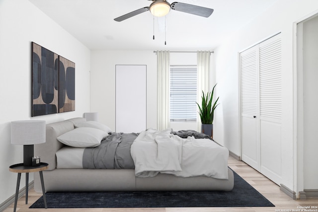 bedroom with ceiling fan and light hardwood / wood-style flooring