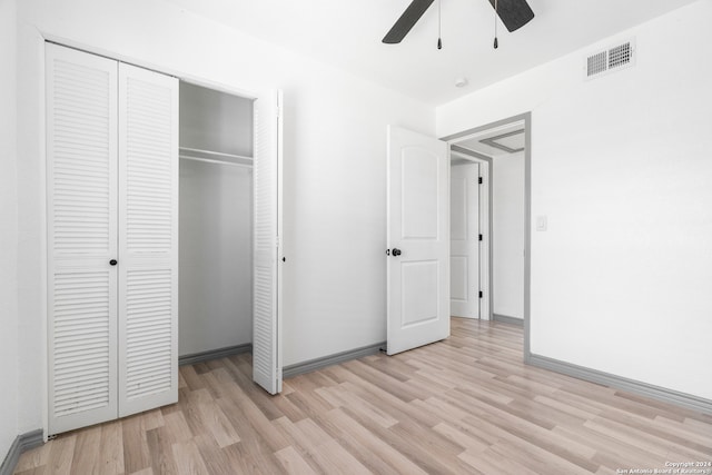 unfurnished bedroom with ceiling fan, a closet, and light hardwood / wood-style floors