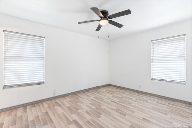 spare room featuring light hardwood / wood-style floors and ceiling fan