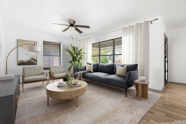 living room with light wood-type flooring and ceiling fan