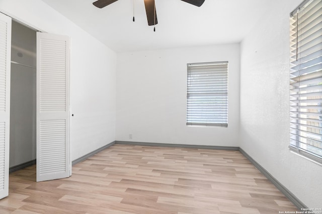 214 Oriole, San Antonio, TX 78228 - unfurnished bedroom featuring light wood-type flooring, a ceiling fan, baseboards, and a closet