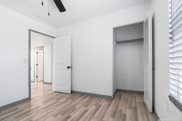 unfurnished bedroom with a closet, light hardwood / wood-style floors, and ceiling fan