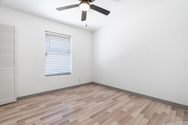 empty room featuring ceiling fan and light hardwood / wood-style flooring