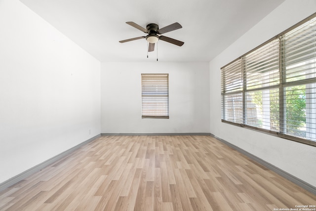 empty room featuring light hardwood / wood-style flooring and ceiling fan