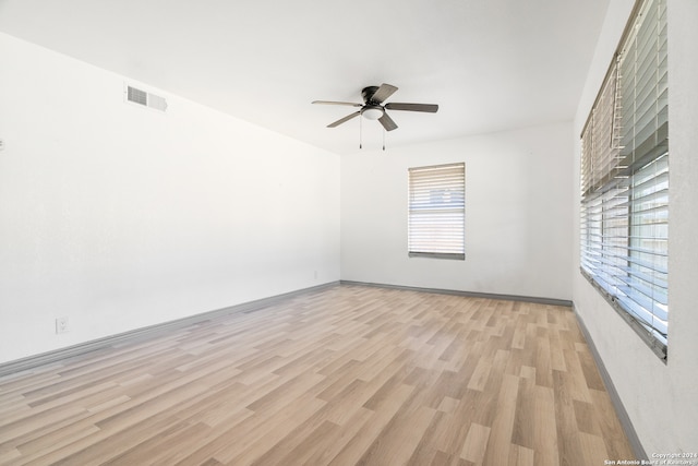 unfurnished room with light wood-type flooring and ceiling fan