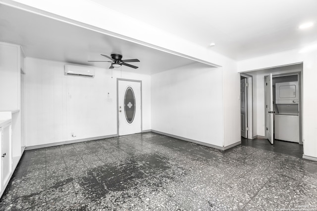 unfurnished living room with stacked washer and clothes dryer, ceiling fan, and a wall mounted AC