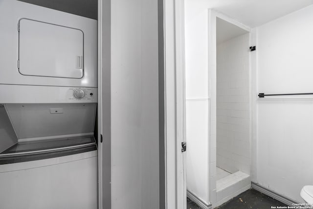 laundry room with stacked washer / drying machine