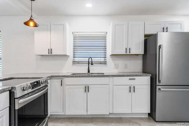 214 Oriole, San Antonio, TX 78228 - kitchen with white cabinetry, light stone counters, a sink, decorative light fixtures, and stainless steel appliances