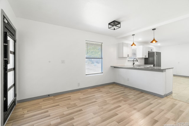 kitchen with stainless steel fridge, kitchen peninsula, light hardwood / wood-style flooring, and white cabinets