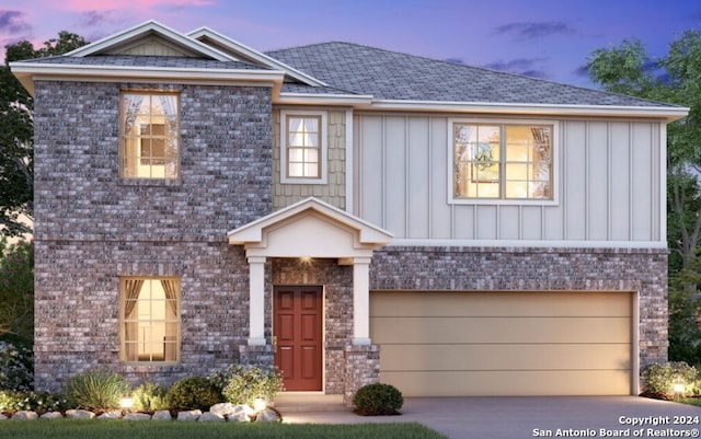 view of front facade with an attached garage, brick siding, board and batten siding, and driveway