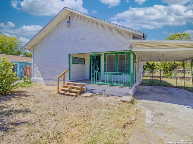 view of front of property with a porch and a carport