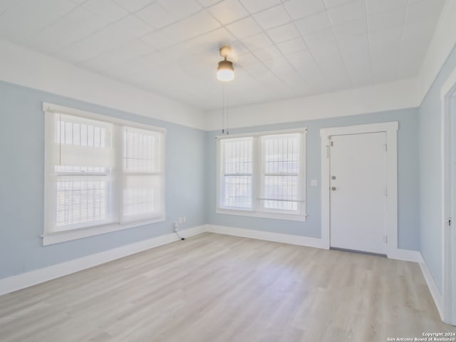 unfurnished room with light wood-type flooring and a healthy amount of sunlight