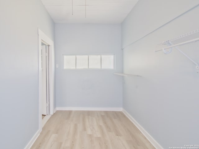 spacious closet with light hardwood / wood-style flooring