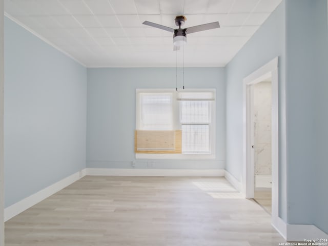 empty room with ceiling fan and light hardwood / wood-style flooring