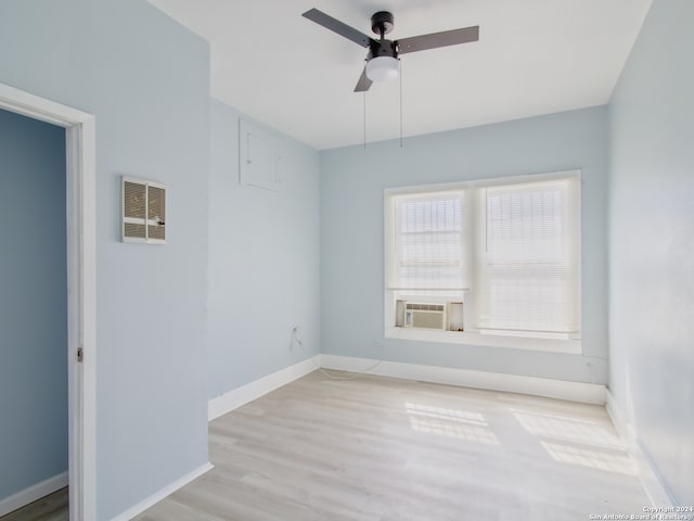 unfurnished room featuring ceiling fan, cooling unit, and light hardwood / wood-style flooring