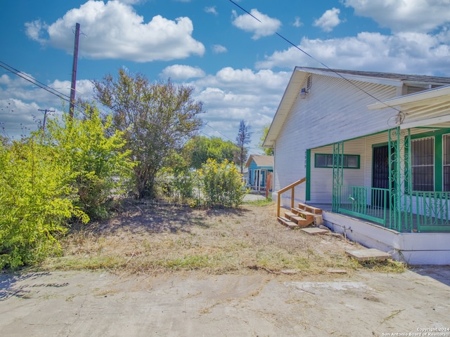 view of yard with covered porch