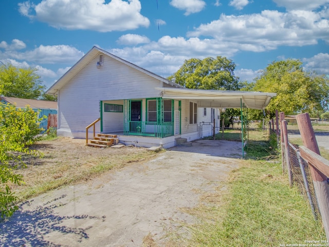 view of front facade with a porch and a carport