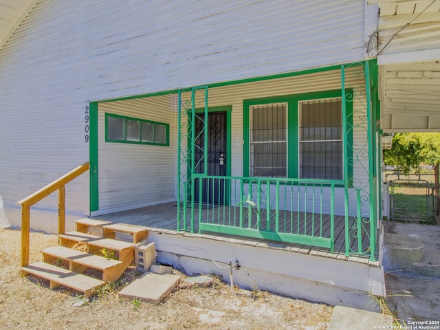 view of exterior entry featuring a porch