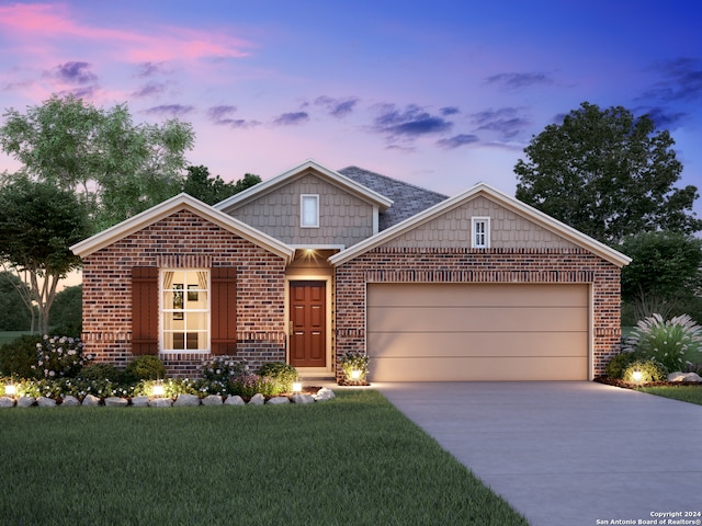 view of front of home featuring a garage and a yard