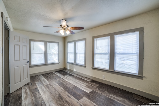 unfurnished room featuring ceiling fan, a textured ceiling, and dark hardwood / wood-style floors