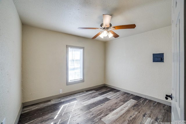 unfurnished room with a textured wall, baseboards, a ceiling fan, and wood finished floors