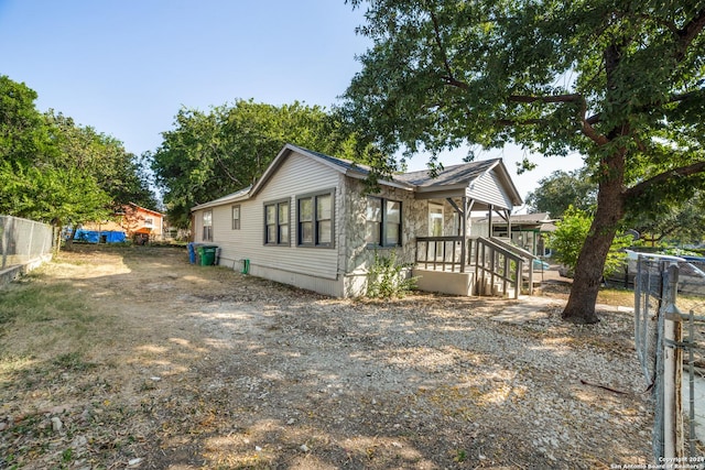 view of property exterior featuring fence