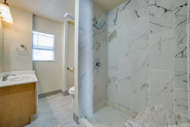 full bathroom with vanity, baseboards, walk in shower, toilet, and visible vents