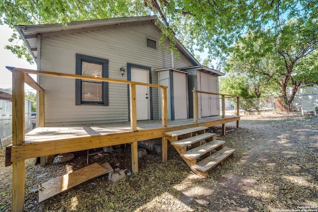 back of house with fence and a wooden deck
