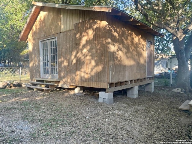 view of side of property with entry steps and fence