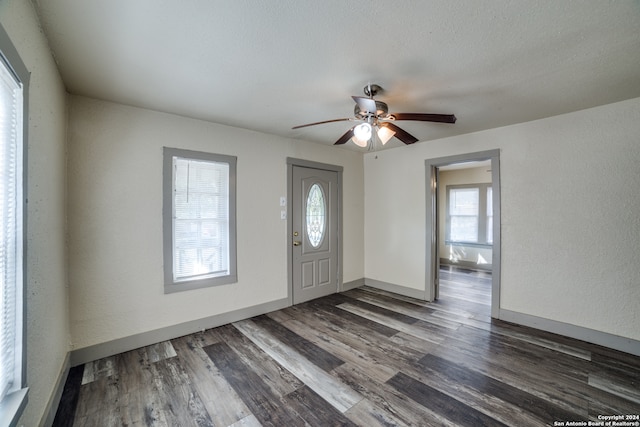 entryway with ceiling fan, a textured ceiling, and dark hardwood / wood-style floors