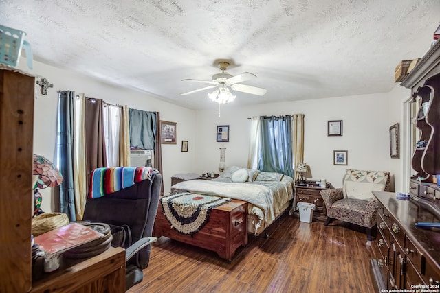 bedroom with ceiling fan, a textured ceiling, and dark hardwood / wood-style flooring