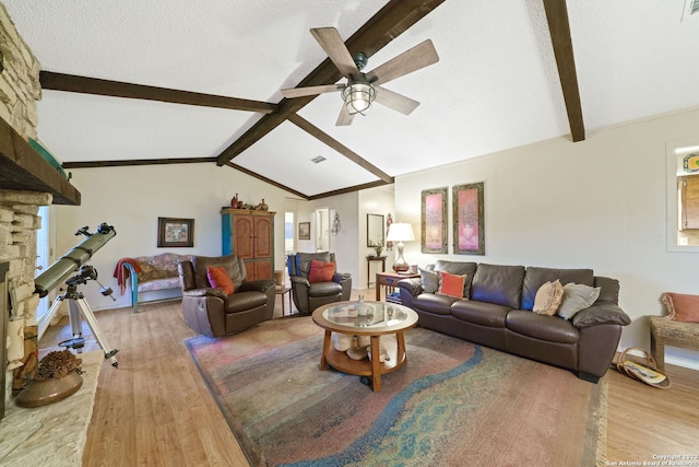 living room with wood-type flooring, lofted ceiling with beams, a textured ceiling, and ceiling fan